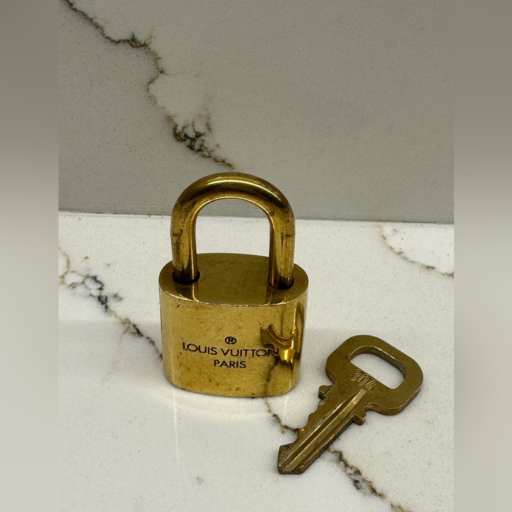 Louis Vuitton gold Padlock Keychain #304 used in excellent condition.